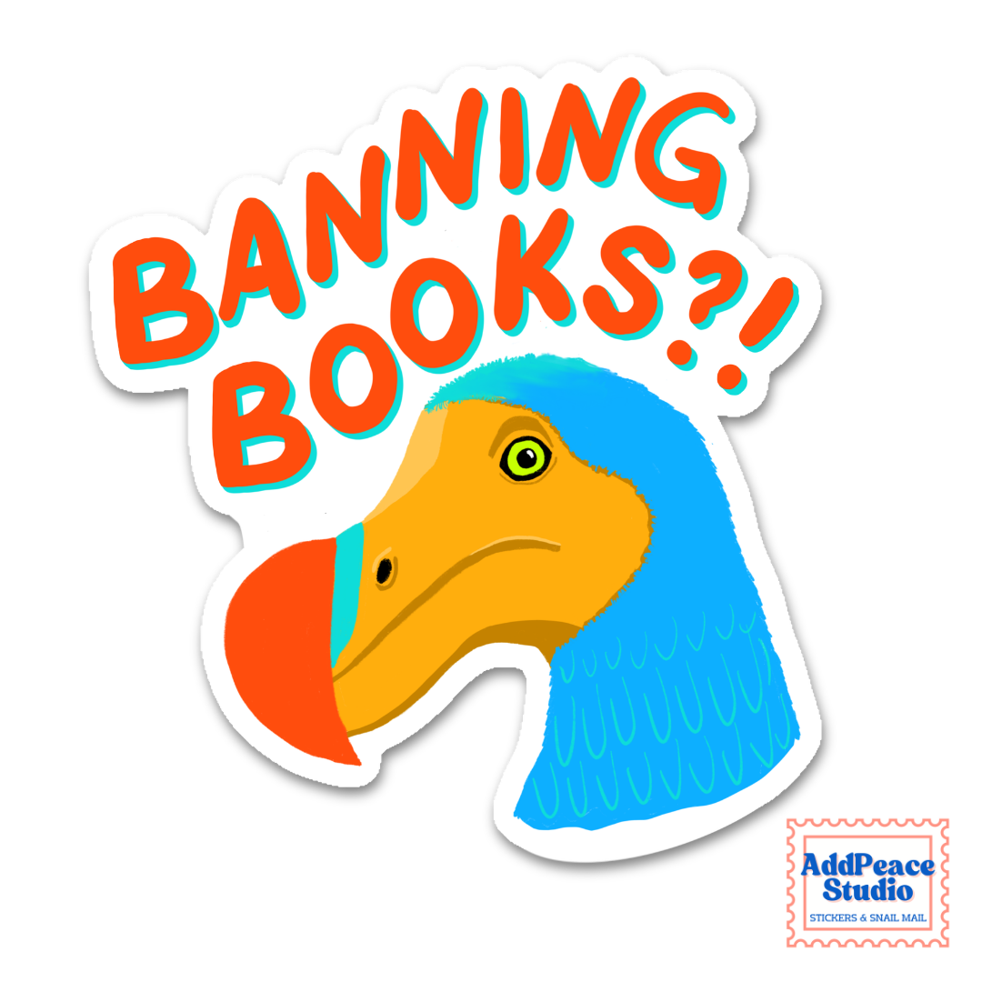 A die-cut sticker featuring a cartoon Dodo bird head with a blue neck, yellow beak, and green eye, beneath large orange text reading “BANNING BOOKS?!” on a white background. A small “AddPeace Studio” mark appears in the bottom-right corner.