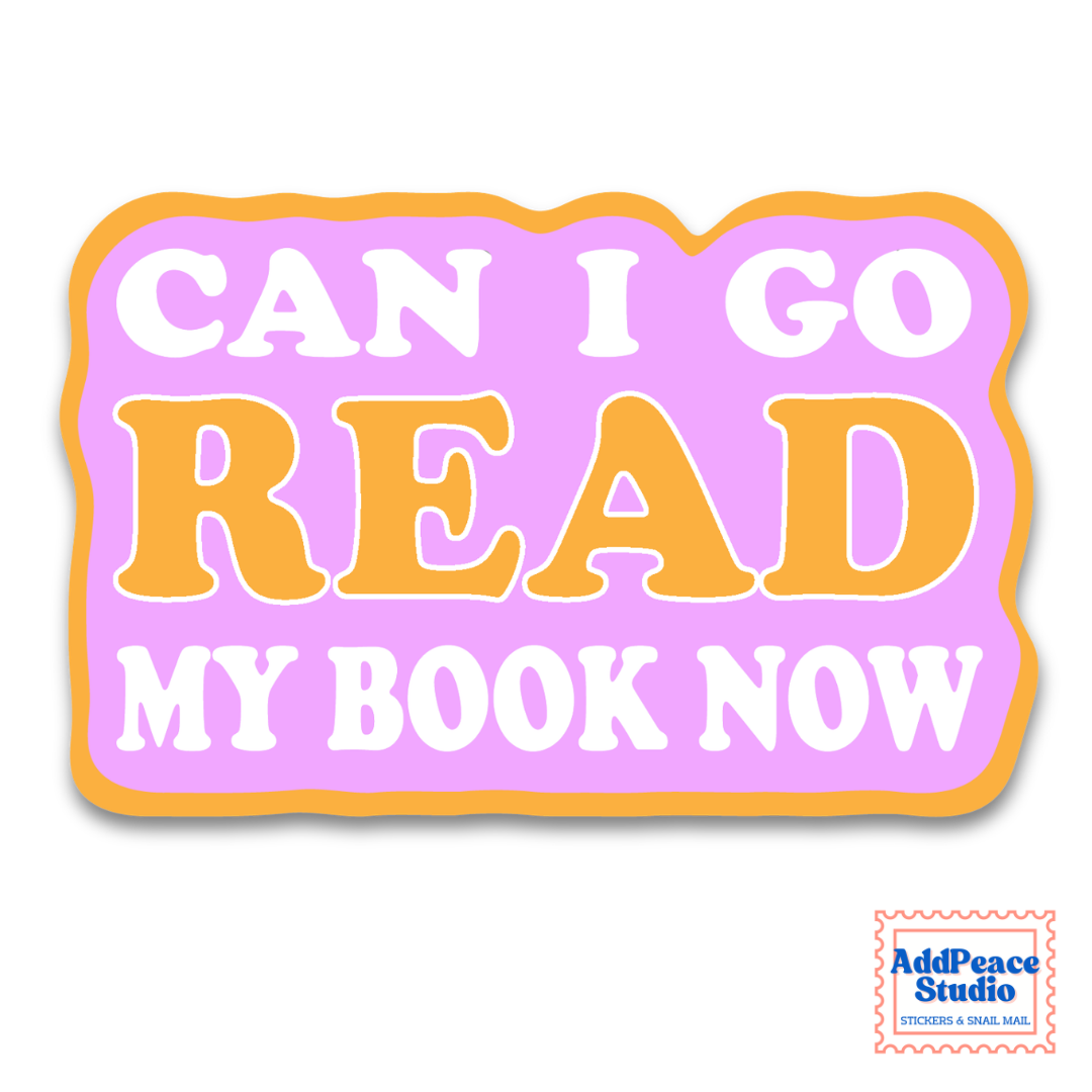 A die-cut sticker with the text 'CAN I GO READ MY BOOK NOW' in white and orange lettering on a pastel pink background with an orange border. A small 'AddPeace Studio' logo is visible in the bottom right corner.