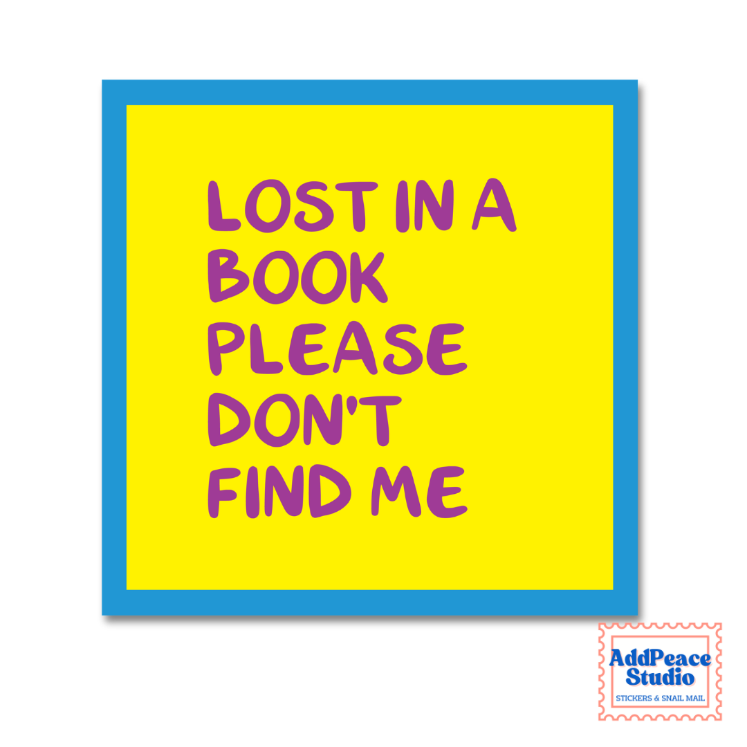 A square yellow sticker with a blue border and purple text that reads 'LOST IN A BOOK PLEASE DON'T FIND ME'. A small 'AddPeace Studio' logo is visible in the bottom right corner.