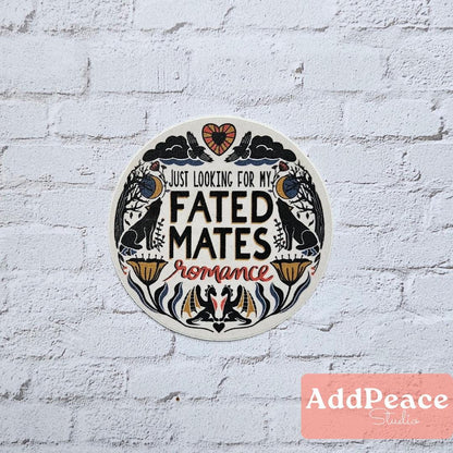 Circular sticker with text 'Just looking for my fated mates romance' on a white brick wall background, with 'AddPeace Studio' branding.
