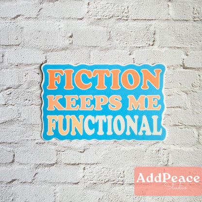 Sticker with 'FICTION KEEPS ME FUNCTIONAL' text on a white brick wall, featuring the brand 'AddPeace Studio'.