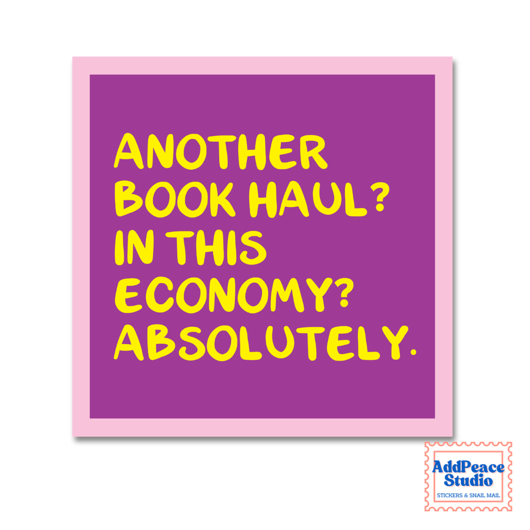 A square sticker with a purple background and a light pink border, featuring the text 'ANOTHER BOOK HAUL? IN THIS ECONOMY? ABSOLUTELY.' in bold yellow lettering.