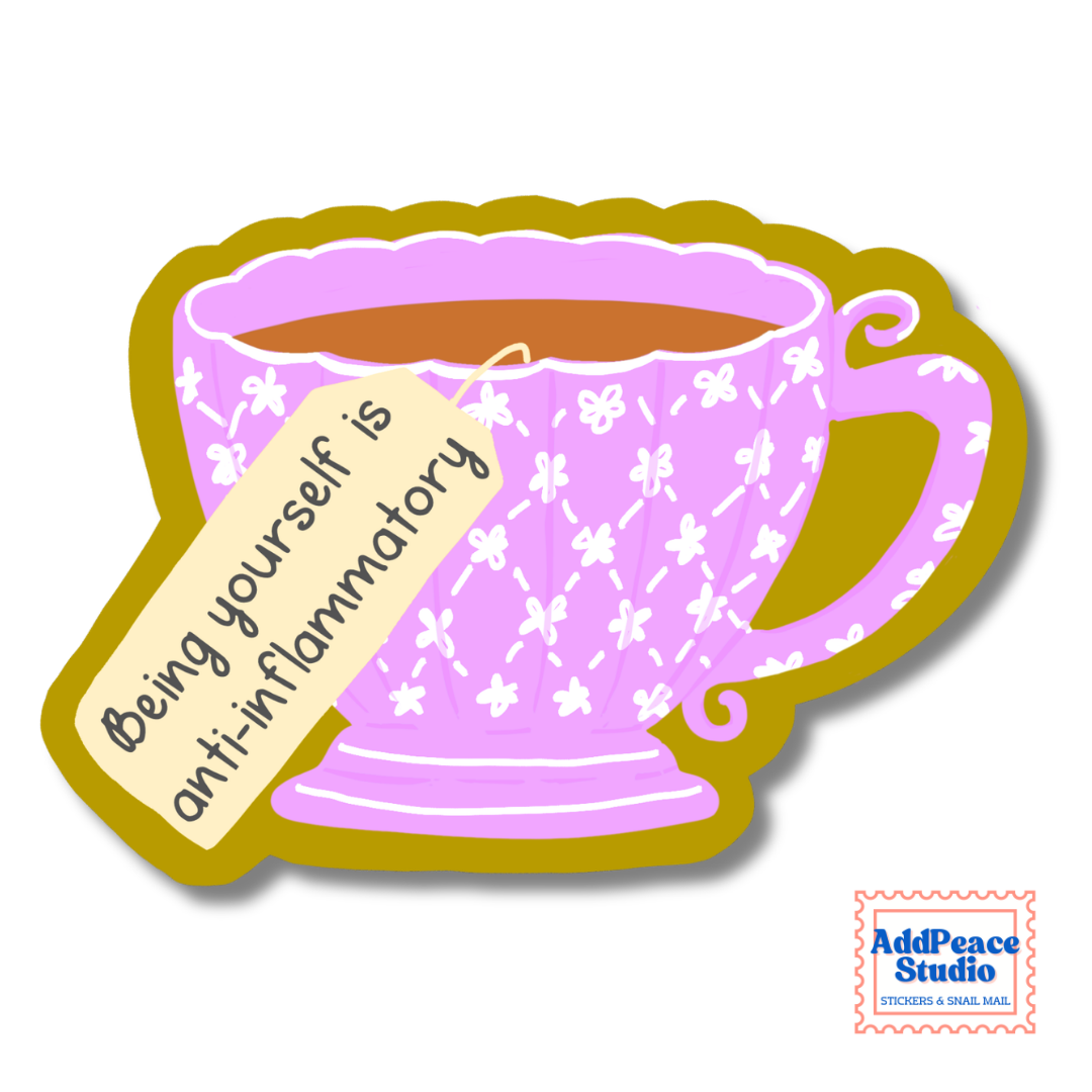 A die-cut sticker featuring a pink floral teacup with a tea bag tag that reads 'Being yourself is anti-inflammatory'. The sticker has a mustard yellow border and is shown on a white background with an 'AddPeace Studio' watermark in the bottom right corner.