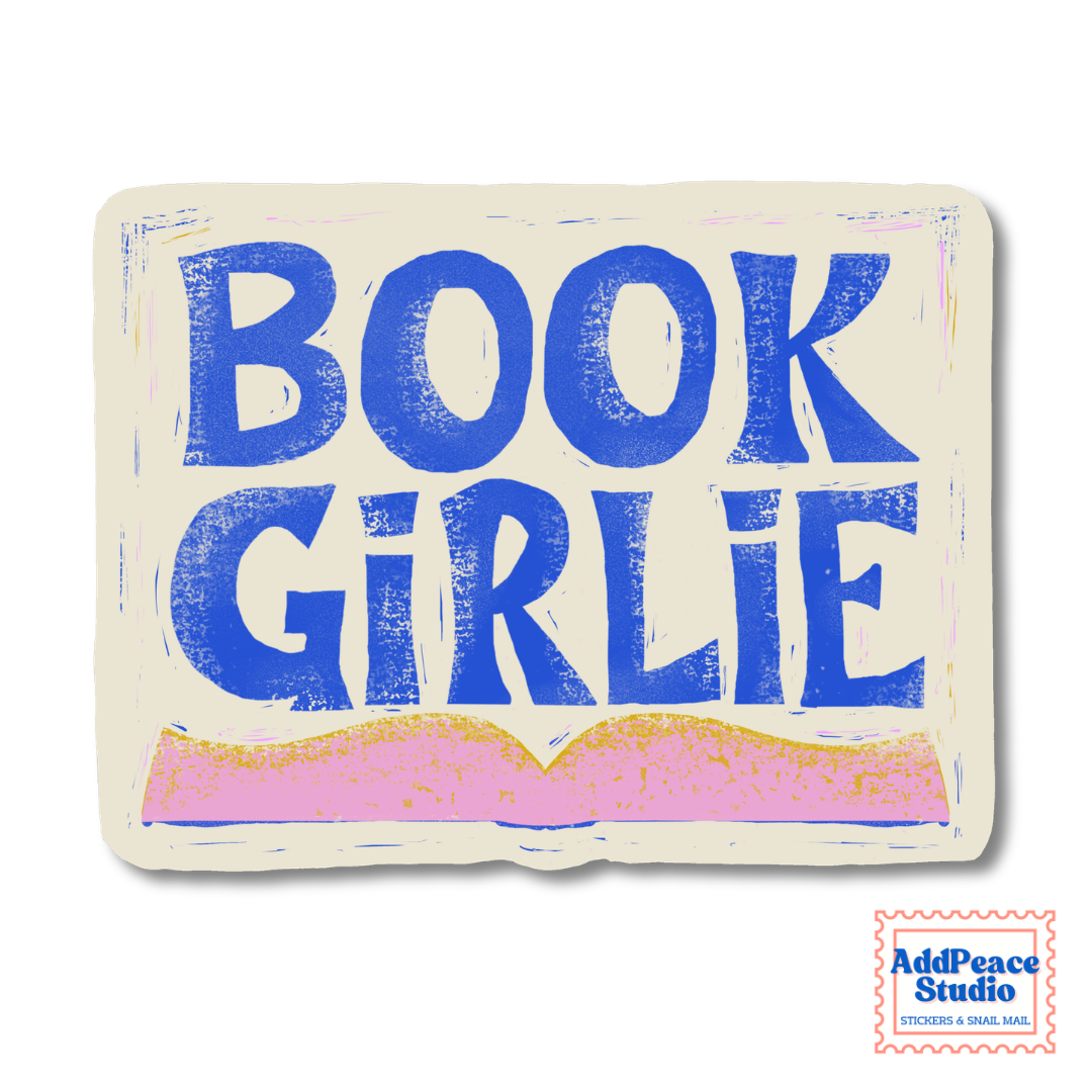 A square cream-colored sticker or label with the words “BOOK GIRLIE” in large blue block letters above a pink open-book illustration. A small “AddPeace Studio” mark appears in the bottom-right corner.