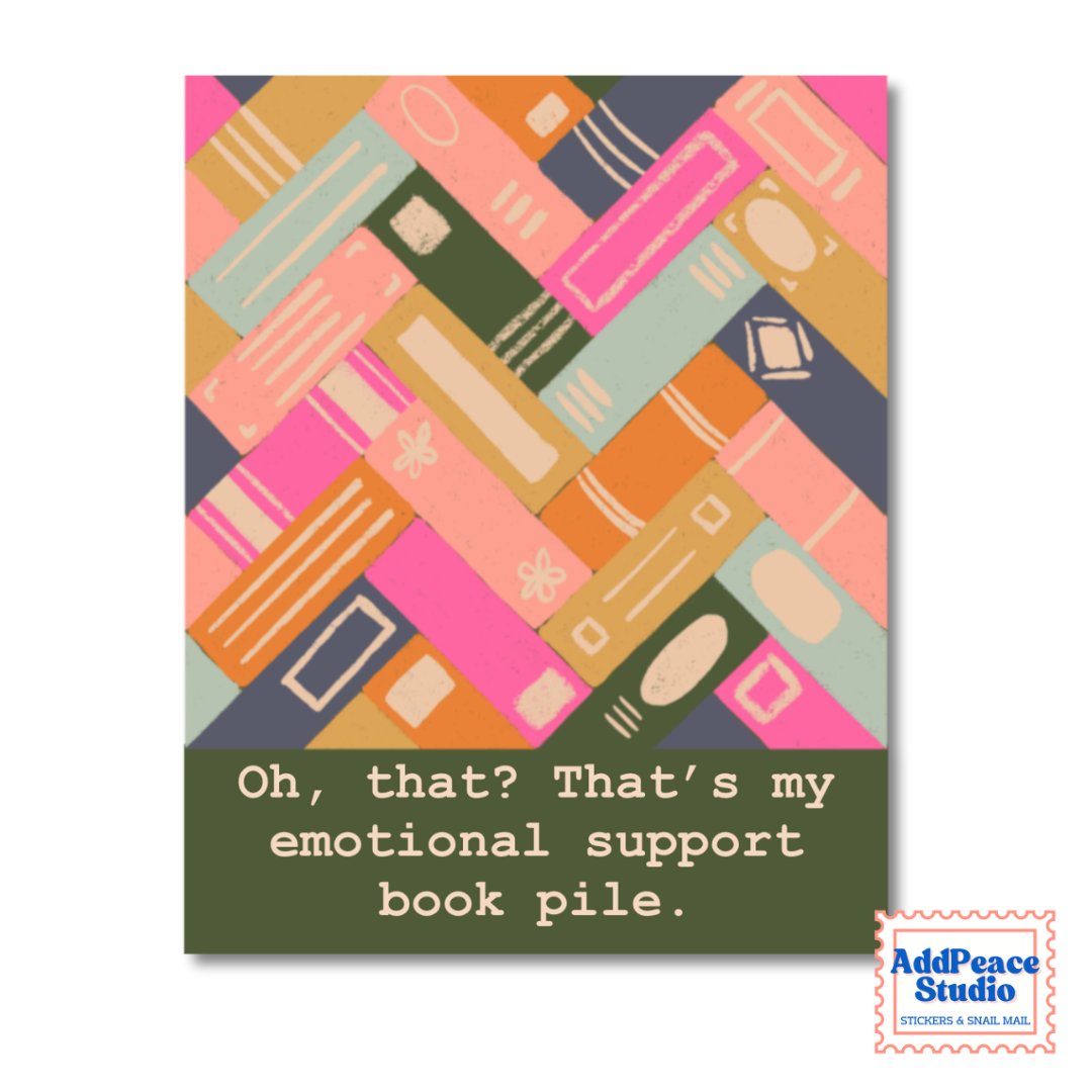 A square sticker design featuring a colorful abstract pattern of stacked books in pink, orange, green, beige, and blue-gray, with a dark olive green bottom section containing the text: 'Oh, that? That's my emotional support book pile.' A small 'AddPeace Studio' logo appears in the bottom-right corner.