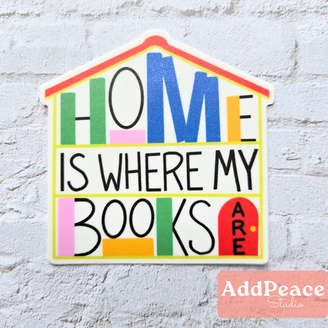 House shaped waterproof vinyl sticker with illustrated bookshelves and “Home Is Where My Books Are” text