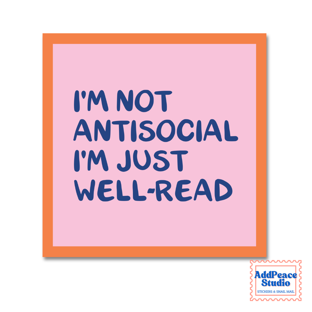 A square pink sticker with an orange border and blue text that reads 'I'M NOT ANTISOCIAL I'M JUST WELL-READ'. A small AddPeace Studio logo is visible in the bottom right corner.