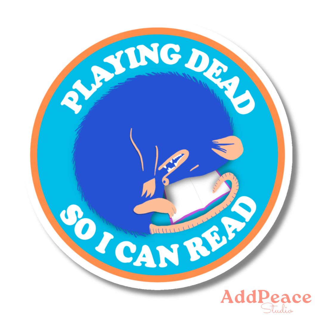 Curled up possum reading a book vinyl sticker with “Playing Dead So I Can Read” text