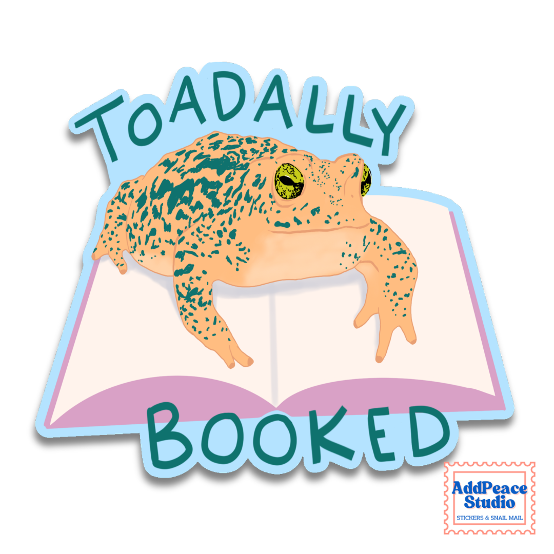 A die-cut sticker featuring a cartoon toad sitting on an open book with the words 'TOADALLY BOOKED' in teal lettering. The sticker has a light blue outline and is shown on a white background with a small 'AddPeace Studio' logo in the bottom right corner.